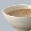 White ceramic bowl with textured interior on a gray background