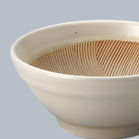 White ceramic bowl with textured interior on a gray background